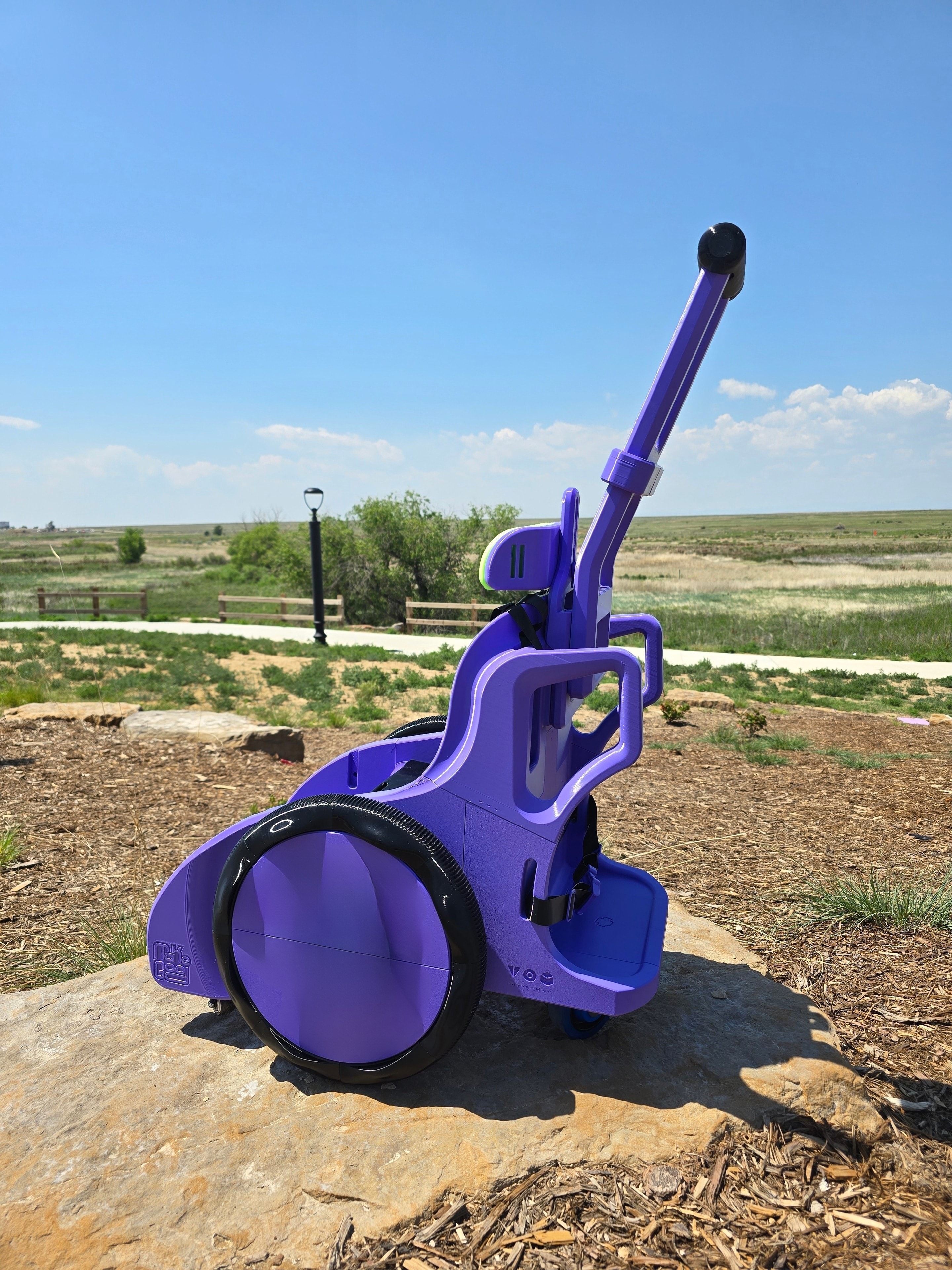 Custom purple mobility device side view outdoors