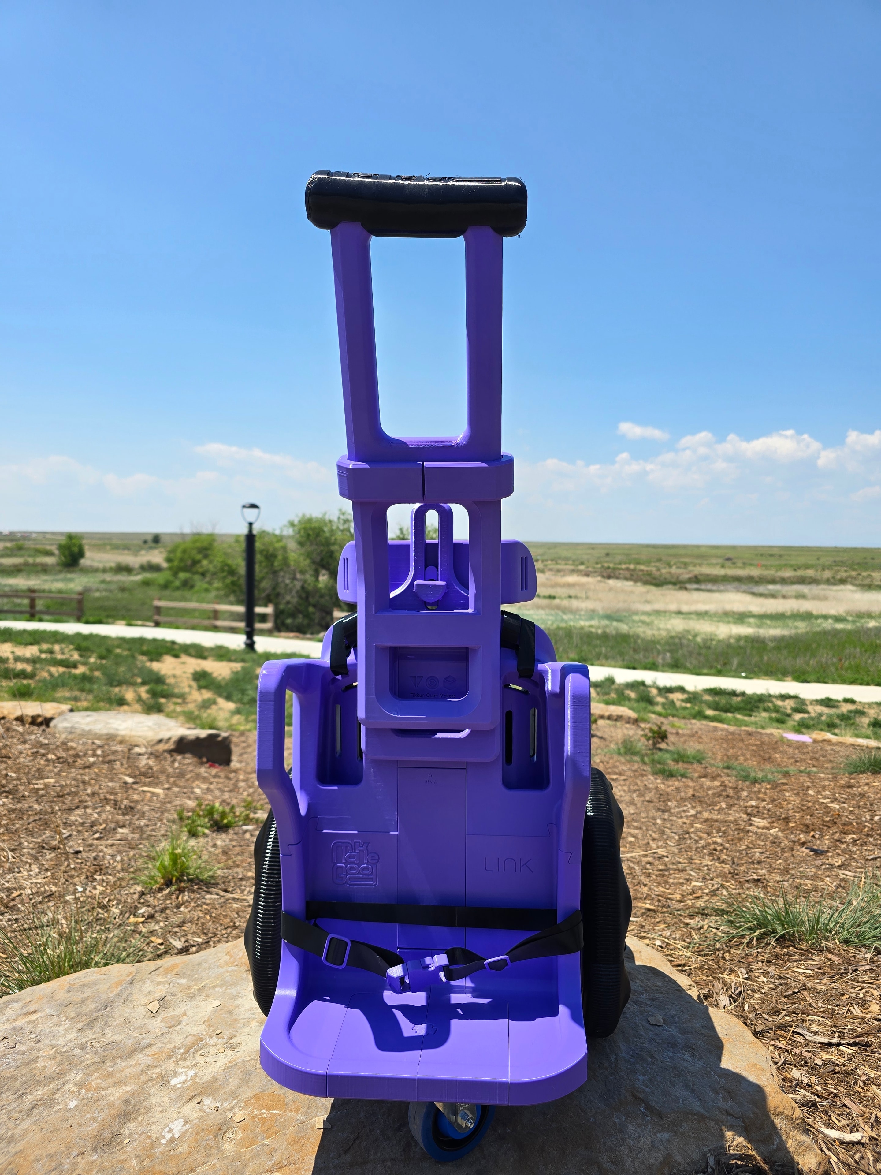 Custom purple mobility device rear view outdoors